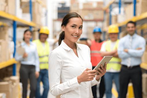 Female professional with group in warehouse