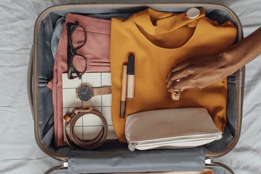 Open luggage with travel essentials