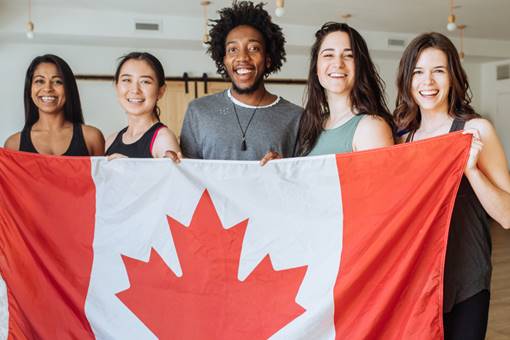 Diverse students holding Canada flag