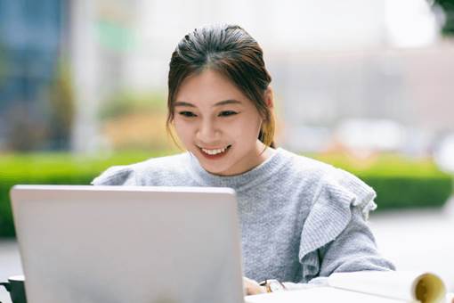 Female Asian Student Studying with Laptop